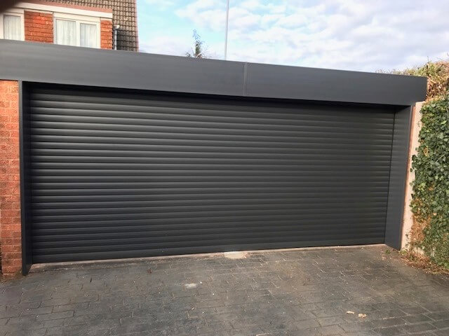 Newly installed dark grey roller garage door