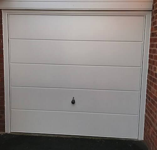 White up and over garage door installation with black handle