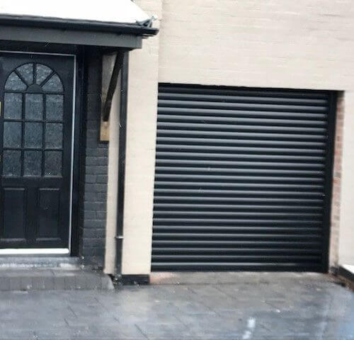 Black garage door in snow