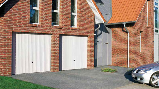 double white up and over garage doors with black handles