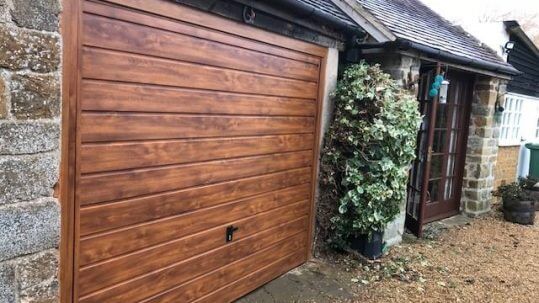 Love the warmth of a stylish wood grained garage door?